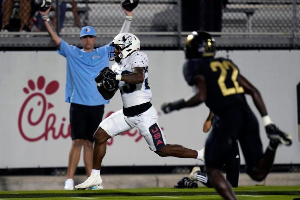 UCF running back Demarkcus Bowman, front left, runs for a 20-yard touchdown past defensive back Jason Duclona (22) during the first half of the NCAA college football team's annual spring game, Friday, April 14, 2023, in Orlando.