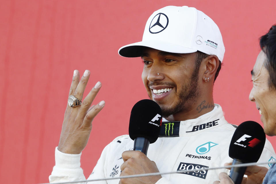 My precious: Lewis Hamilton tries Takuma Sato’s Indy 500 winner’s ring on for size, at the Suzuka podium ceremony