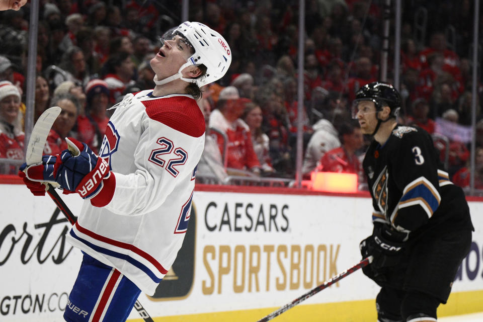 Montreal Canadiens right wing Cole Caufield (22) celebrates after his goal as Washington Capitals defenseman Nick Jensen (3) looks on during the second period of an NHL hockey game Saturday, Dec. 31, 2022, in Washington. (AP Photo/Nick Wass)