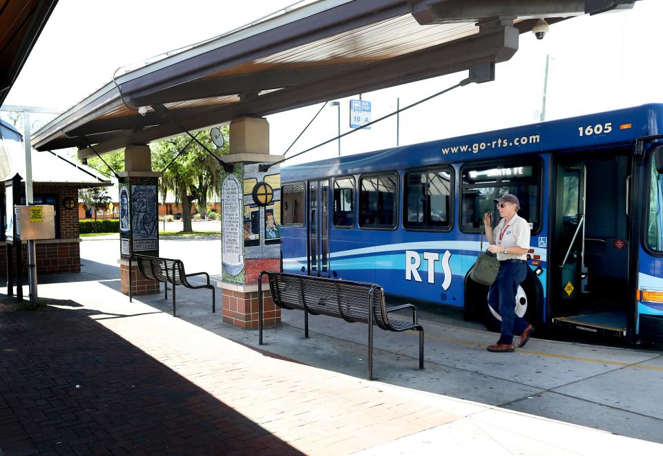A Regional Transit System driver gets off a bus by himself after pulling into the RTS Rosa Parks Transfer Station off SE 3rd Street in Gainesville, Fla. on March 20, 2020.