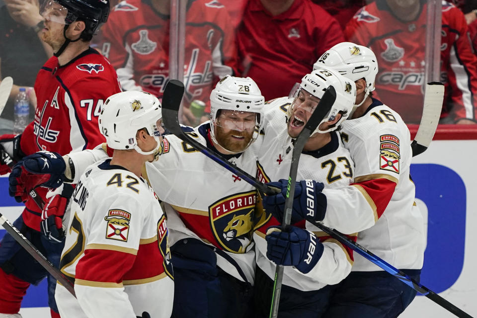 Florida Panthers defenseman Gustav Forsling, right wing Claude Giroux, center Carter Verhaeghe and center Aleksander Barkov, from left, celebrate Giroux's goal against the Washington Capitals during the third period of Game 6 of a first-round NHL hockey Stanley Cup playoff series Friday, May 13, 2022, in Washington. (AP Photo/Alex Brandon)