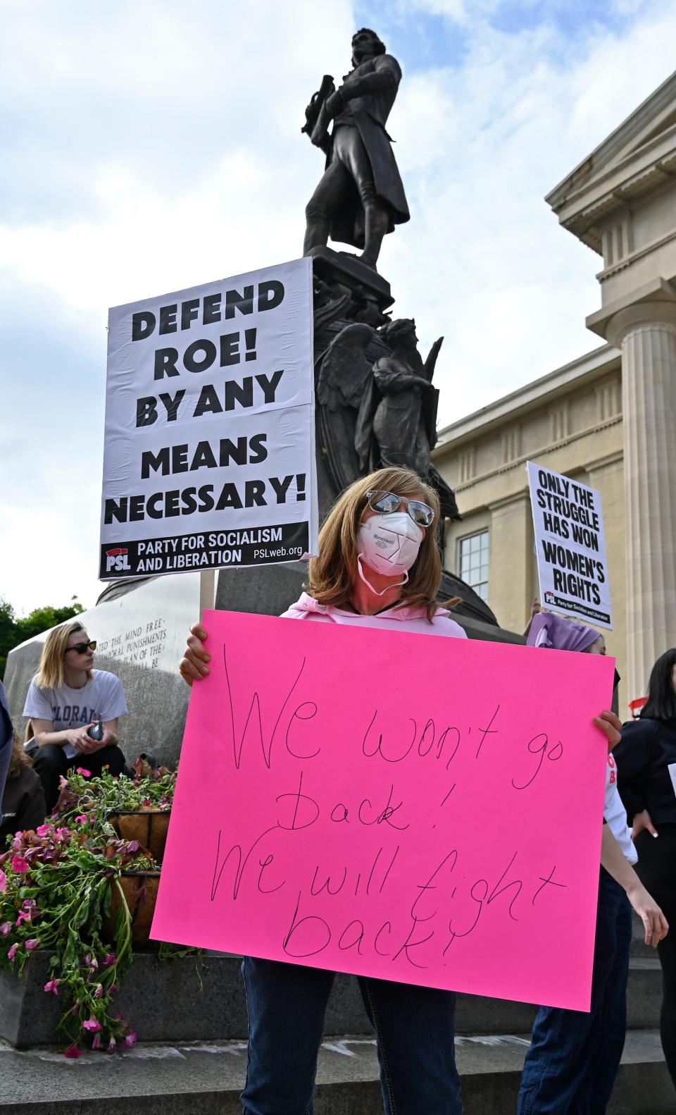 An abortion rights supporter stands in front of the statue of Thomas Jefferson during an abortion rights rally outside the Louisville Metro Hall, Wednesday, May. 4, 2022 in Louisville Ky.