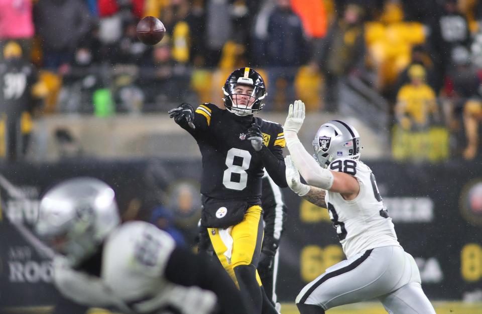 Pittsburgh Steelers Kenny Pickett (8) throws downfield while being pressured by Las Vegas Raiders Maxx Crosby (98) during the second half at Acrisure Stadium in Pittsburgh, PA on December 24, 2022.