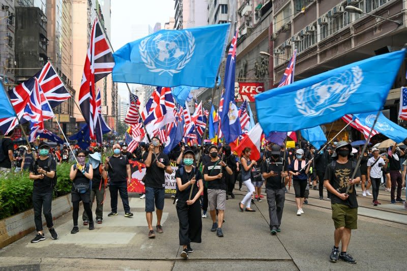 Protesters carry flags of the United Nations, Great Britain and other countries during an anti-government rally in Hong Kong on Sept. 29, 2019. Police arrested 10 democracy activists Thursday who had supported 2019 protesters by working with the now-defunct 612 Humanitarian Relief Fund. Photo by Thomas Maresca/UPI