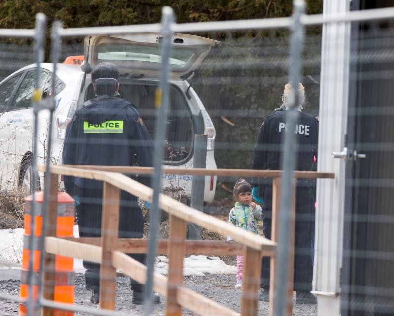 FILE PHOTO: RCMP confront asylum seekers as they cross the border from New York into Canada at Roxham Road, in Hemmingford Quebec