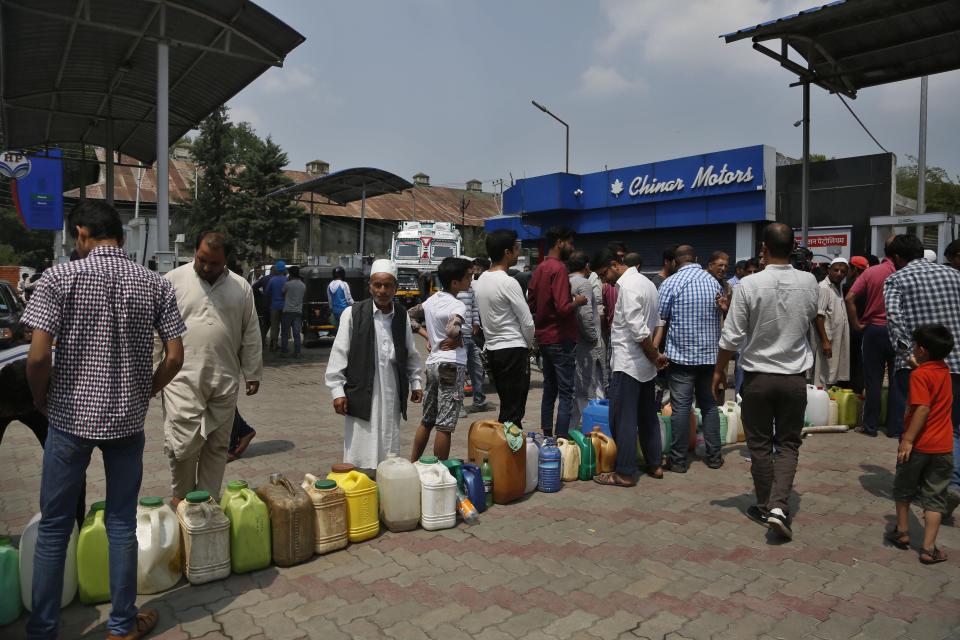 Kashmiri residents queue up at a fuel station in Srinagar, India, Sunday, Aug. 4, 2019. People in Srinagar and other towns in Indian kashmir thronged grocery stores and medical shops to stock up on essentials. Tensions have soared along the volatile, highly militarized frontier between India and Pakistan in the disputed Himalayan region of Kashmir as India deployed more troops and ordered thousands of visitors out of the region. (AP Photo/Mukhtar Khan)