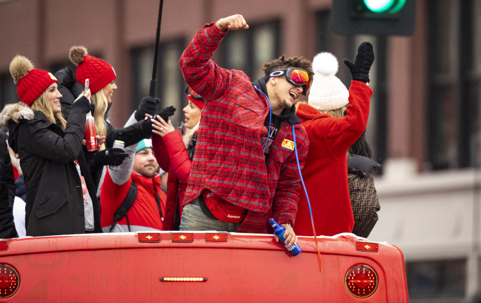 KANSAS CITY, MO - FEBRUARY 05: Patrick Mahomes of the Kansas City Chiefs celebrates atop one of the team buses on February 5, 2020 in Kansas City, Missouri during the citys celebration parade for the Chiefs victory in Super Bowl LIV. (Photo by David Eulitt/Getty Images)