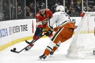 Florida Panthers center Sam Reinhart, left, passes the puck past Anaheim Ducks defenseman John Klingberg during the second period of an NHL hockey game in Anaheim, Calif., Sunday, Nov. 6, 2022. (AP Photo/Alex Gallardo)