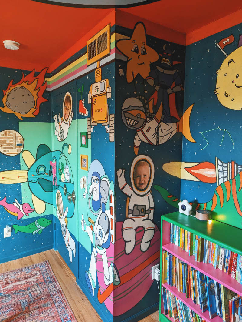 kids room with colorful space and dinosaur themed painted walls and ceiling