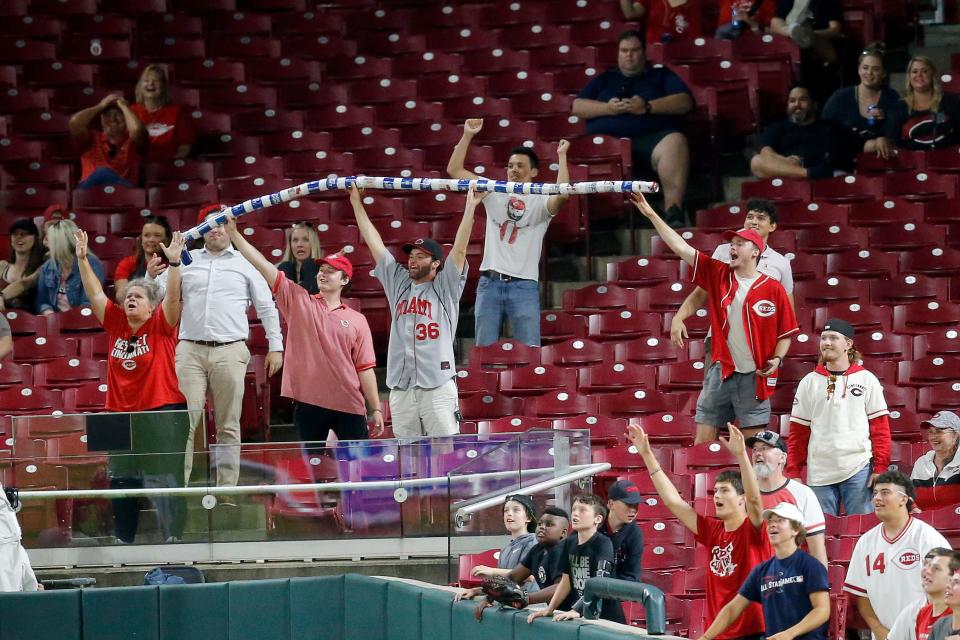 Fans cheer in the right field stands late in the ninth inning of the MLB National League game between the Cincinnati Reds and the Chicago Cubs at Great American Ball Park in downtown Cincinnati on Tuesday, May 24, 2022. The Cubs won 11-4. 