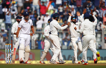 Cricket - India v England - Fourth Test cricket match - Wankhede Stadium, Mumbai, India - 11/12/16. India's Virat Kohli (3rd R) celebrates with team mates the wicket of England's Alastair Cook. REUTERS/Danish Siddiqui