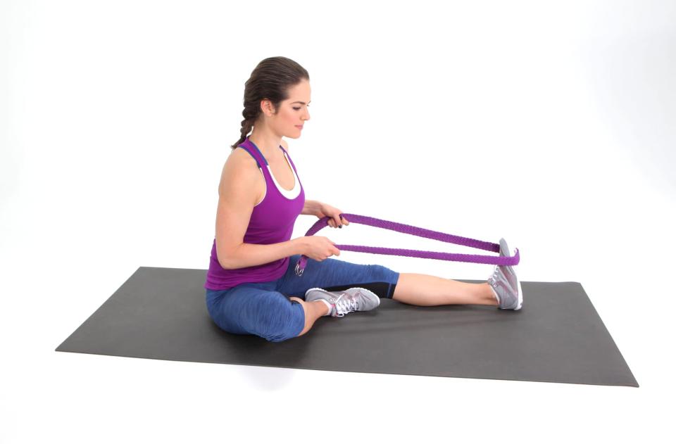 <ul> <li>Sit comfortably on the floor. If the backs of your legs are really tight and you find yourself slumping, sit on a pillow so you can keep your spine straight. </li> <li>Fold your right leg in and reach your left leg long.</li> <li>Wrap a yoga strap or Theraband (or an old tie or belt from your bathrobe) around the ball of your left foot. </li> <li>Use the strap to pull your toes toward your head.</li> <li>Do not jam your knee into the floor. Keep your left heel on the ground.</li> <li>Hold for 20 to 30 seconds, then repeat on the other side.</li> </ul>