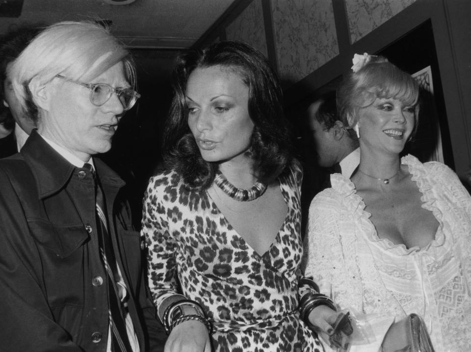 Diane von Furstenberg (C) photographed with Andy Warhol (L) and Monique Van Vooren in New York City in 1974.