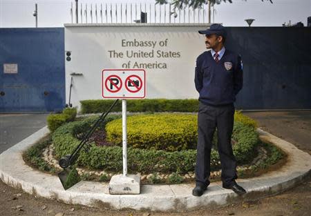A private security guard stands outside the U.S. embassy in New Delhi December 18, 2013. REUTERS/Anindito Mukherjee