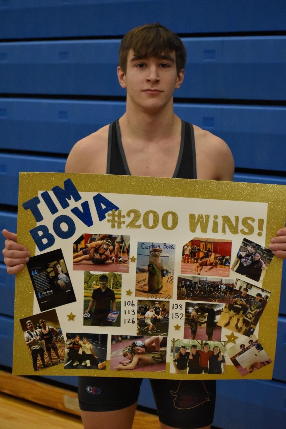 Arlington wrestler Tim Bova poses with a cardboard collage of photos commemorating career highlights after notching his 200th win at the Coxsackie-Athens Duals on Jan. 22, 2020.