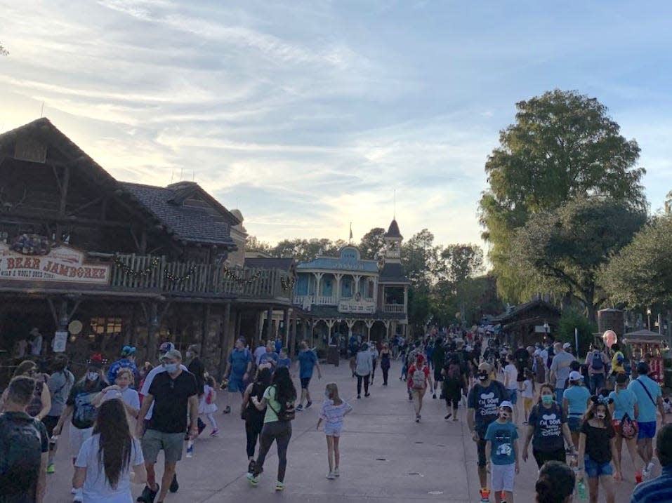 Magic Kingdom guests walking one of the throughways of Frontierland