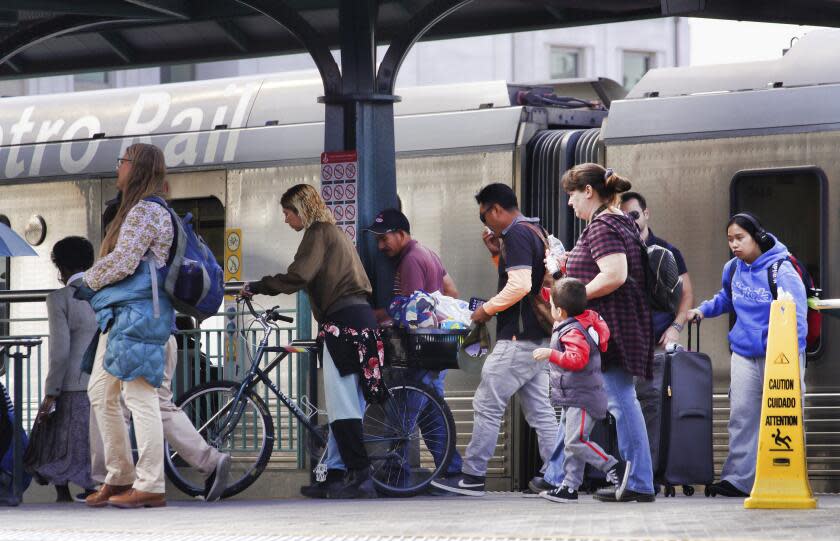 Commuters disembark from a Metro Rail train at Union Station in Downtown Los Angeles on Monday, Nov. 13, 2023. Los Angeles drivers are being tested in their first commute since a weekend fire that closed a major elevated interstate near downtown. Commuters were urged to work from home or take public transportation into downtown Los Angeles. (AP Photo/Richard Vogel)