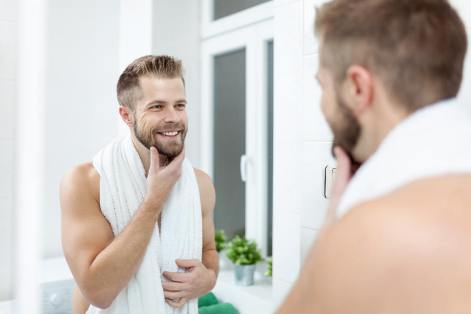 Morning hygiene, Handsome man in the bathroom looking in mirror