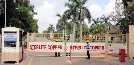 A private security guard stands in front of the main gate of Sterlite Industries Ltd's copper plant in Tuticorin, in Tamil Nadu, March 24, 2013. REUTERS/Stringer/Files