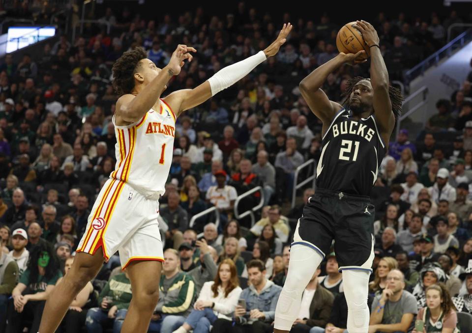 Milwaukee Bucks guard Jrue Holiday (21) shoots against Atlanta Hawks' Jalen Johnson during the second half of an NBA basketball game Saturday, Oct. 29, 2022, in Milwaukee. The Bucks won 123-115. (AP Photo/Jeffrey Phelps)