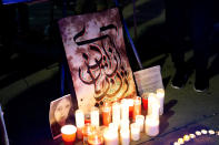 <p>A handmade sign by calligrapher Faramarza Karimi, reading "Woman, Life, Freedom", in Kurdish calligraphy, at a candlelit vigil following the death of a young Iranian Kurdish woman, Zhina Mahsa Amini, outside the Wilshire Federal Building in Los Angeles, California, U.S., September 22, 2022. REUTERS/Bing Guan</p> 