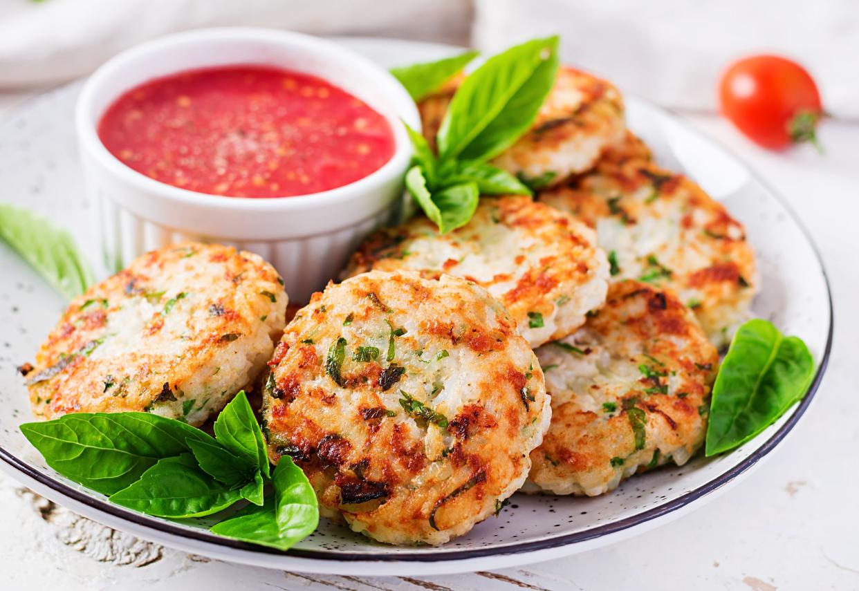 Delicious rice and chicken meat patties with garlic tomato sauce. Diet food.