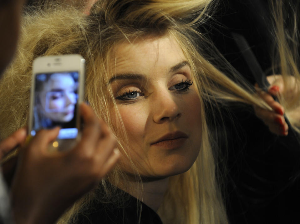 A model is preped backstage before the showing of the Phillip Lim Spring, 2013 collection during Fashion Week, Monday, Sept. 10, 2012, in New York. (AP Photo/Louis Lanzano)