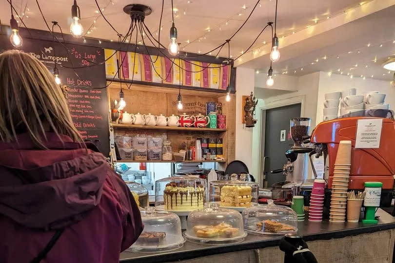 A counter full of cakes inside The Lamppost Cafe