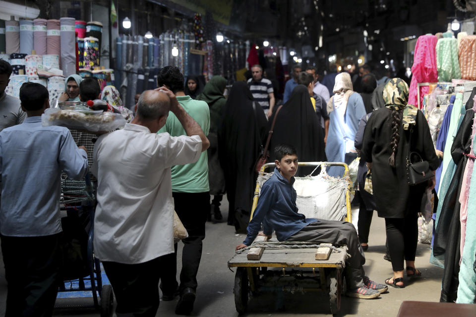 A young worker sits on his hand cart at the old main bazaar in Tehran, Iran, Sunday, June 23, 2019. As the U.S. piles sanction after sanction on Iran, it’s the average person who feels it the most. (AP Photo/Ebrahim Noroozi)