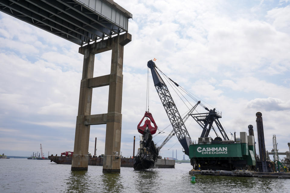 Workers remove wreckage of the collapsed Francis Scott Key Bridge, Thursday, April 25, 2024, in Baltimore. (AP Photo/Matt Rourke)