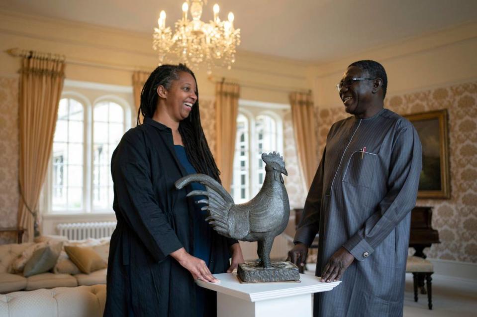 Master of Jesus College Sonita Alleyne, left and Director General of Nigeria’s National Commission for Museums and Monuments Professor Abba Isa Tijani pose for a photo ahead of a ceremony at Jesus College Cambridge, where the looted bronze cockerel, known as the Okukur, will be returned to Nigeria, in Cambridge, England, Wednesday, Oct. 27, 2021. Jesus College announced in 2019 that it would return the Okukor, a statue that was taken from the Court of Benin in what is now Nigeria by British colonial forces in 1897. (Joe Giddens/PA via AP)