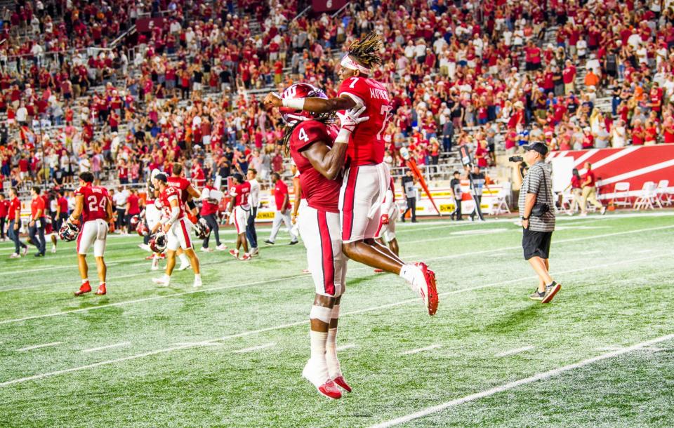 Indiana's Cam Jones (4) and D.J. Matthews (7) students celebrate the winning the game after the Indiana versus Illinois football game at Memorial Stadium on Friday, Sept. 2, 2022.