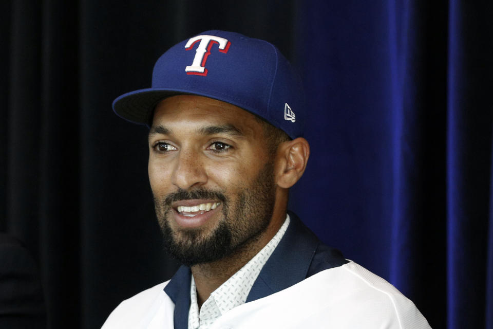 New Texas Rangers infielder Marcus Semien answers questions at a press conference at Globe Life Field Wednesday, Dec. 1, 2021, in Arlington, Texas. The Texas Rangers have finalized the contracts for their new half-billion dollar middle infield, wrapping up their deals Wednesday with two-time All-Star shortstop Corey Seager and Gold Glove second baseman Marcus Semien.(AP Photo/Richard W. Rodriguez)