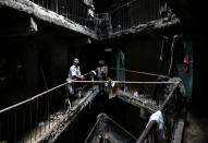 <p>A man stands in a building earmarked for demolition in the Mathare neighborhood of Nairobi, Kenya, on May 17, 2016. Kenya’s authorities tore down a badly built residential block in the poor Nairobi district on Tuesday. About 250 shoddy buildings could now face demolition after a six-story structure collapsed this month, killing 51 people. (Goran Tomasevic/Reuters)</p>