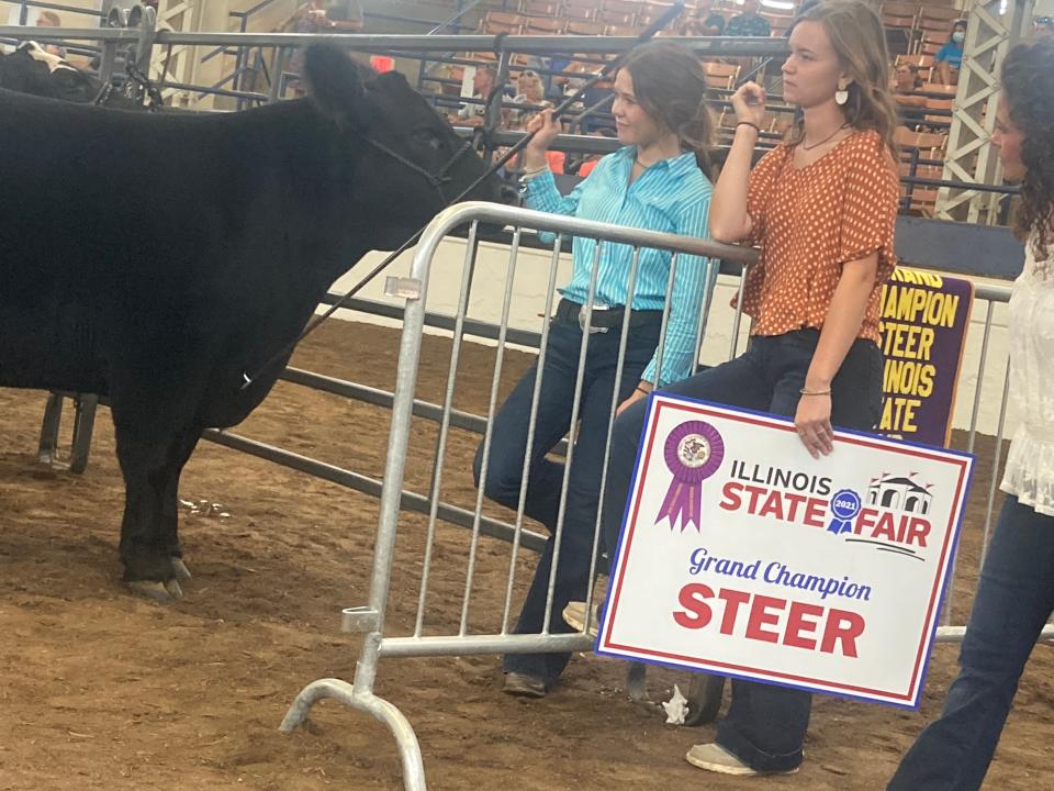 Landrey Freeman of Winchester, left, awaits the Grand Sale of Champions at the 2021 Illinois State Fair. Freeman's steer, Bob, fetched a then-record $105,000.