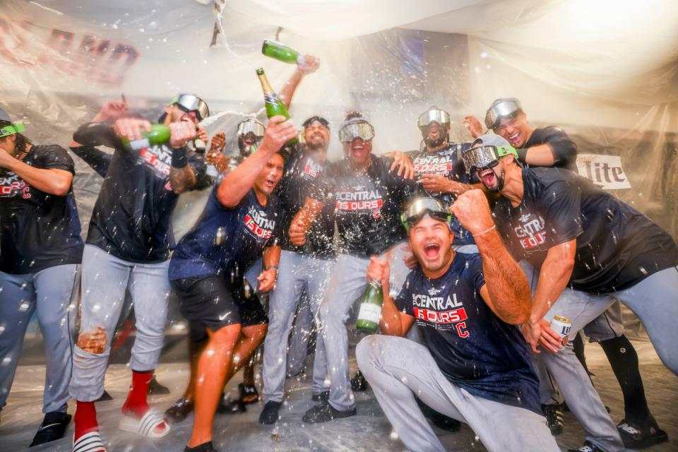 Cleveland Guardians players celebrate winning the American League Central in the locker room after defeating the Texas Rangers in a baseball game in Arlington, Texas, Sunday, Sept. 25, 2022. (AP Photo/Gareth Patterson)