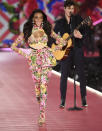 Winnie Harlow, left, walks the runway as Shawn Mendes performs during the 2018 Victoria's Secret Fashion Show at Pier 94 on Thursday, Nov. 8, 2018, in New York. (Photo by Evan Agostini/Invision/AP)