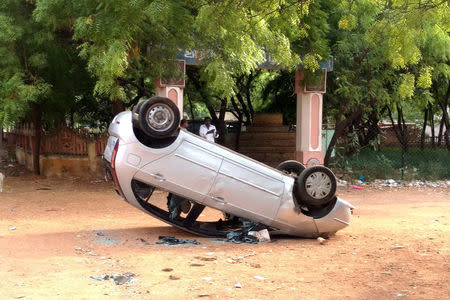 A toppled vehicle is pictured near a government office, after at least 13 people were killed when police fired on protesters seeking closure of plant on environmental grounds in town of Thoothukudi in southern state of Tamil Nadu on Tuesday, May 24, 2018. REUTERS/Sudarshan Varadhan