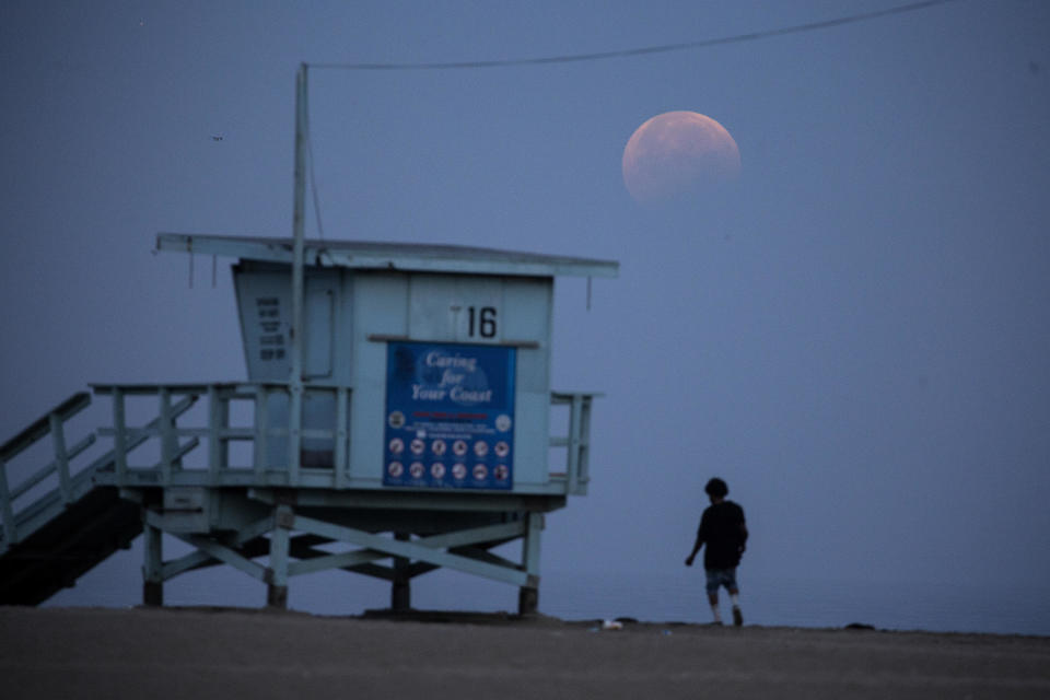 The full moon sets over Santa Monica Beach in Santa Monica, California, Wednesday, May 26, 2021.  / Credit: Ringo H.W. Chiu / AP