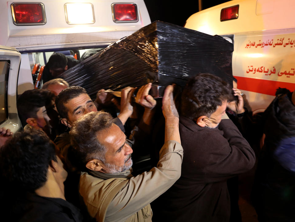 The body of Gaylan Delir Ismael, 25, from Iraq's Kurdish region, arrives at Irbil Airport, Iraq, early Monday, Nov. 15, 2021. Like thousands of other Iraqis and Syrians, Gaylan had traveled to Belarus on an easily obtained tourist visa in the hope of getting to Germany and starting a new life. But he never made it there, dying in a dark and soggy forest on the Belarus-Poland border. (AP Photo)