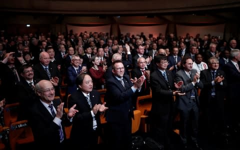 Scientists celebrate after the vote on the redefinition of four base units of the International System of Units - Credit: REUTERS/Benoit Tessier