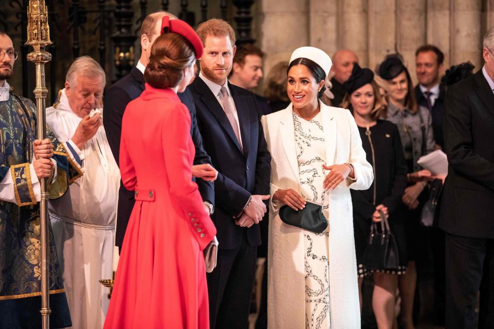 The Duchess of Cambridge (foreground) and Duchess of Sussex greet each other as they attend the Commonwealth Service with other members of the royal family at Westminster Abbey on March 11, 2019. (Photo: RICHARD POHLE via Getty Images)