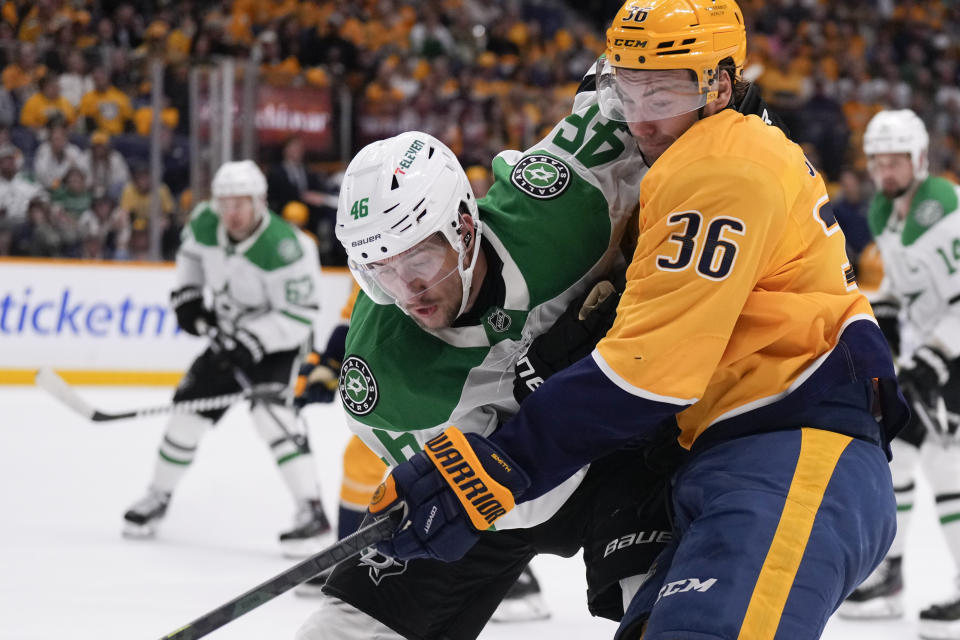 Dallas Stars defenseman Ilya Lyubushkin (46) and Nashville Predators left wing Cole Smith (36) collide as they chase the puck during the second period of an NHL hockey game Thursday, Oct. 10, 2024, in Nashville, Tenn. (AP Photo/George Walker IV)