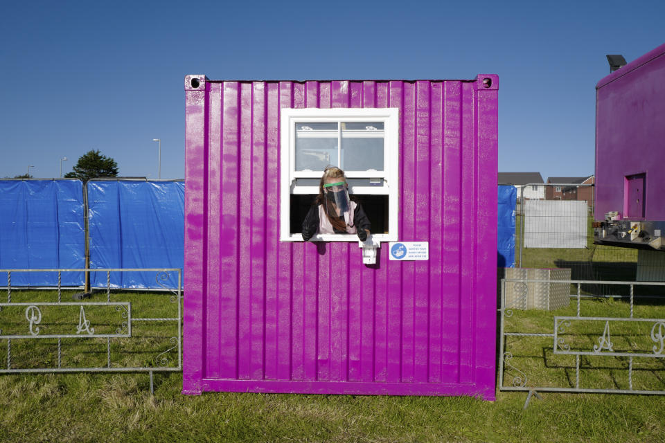 NEWQUAY, ENGLAND - JULY  19: A member of staff wears a protective visor and gloves on the opening night of Britain's first ever drive-in circus performed by The Paulos Circus on July 19, 2020, at Circus Field, Newquay, Cornwall, United Kingdom. Formed in 1816, The Paulos Circus is Britain's oldest circus. The holiday season commenced in Cornwall on July 4th with the lifting of restrictions on hotels, holiday lets and camp sites after three months shutdown. (Photo by Hugh R Hastings/Getty Images)