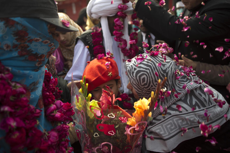 People welcome the family members of missing persons during a march in Rawalpindi, Pakistan, Friday, Feb. 28, 2014. Affected families walked nearly 3,000 kilometers to reach capital Islamabad and register protest against the abductions and killings of their loved ones by Pakistani security agencies without producing them in court of law. (AP Photo/B.K. Bangash)