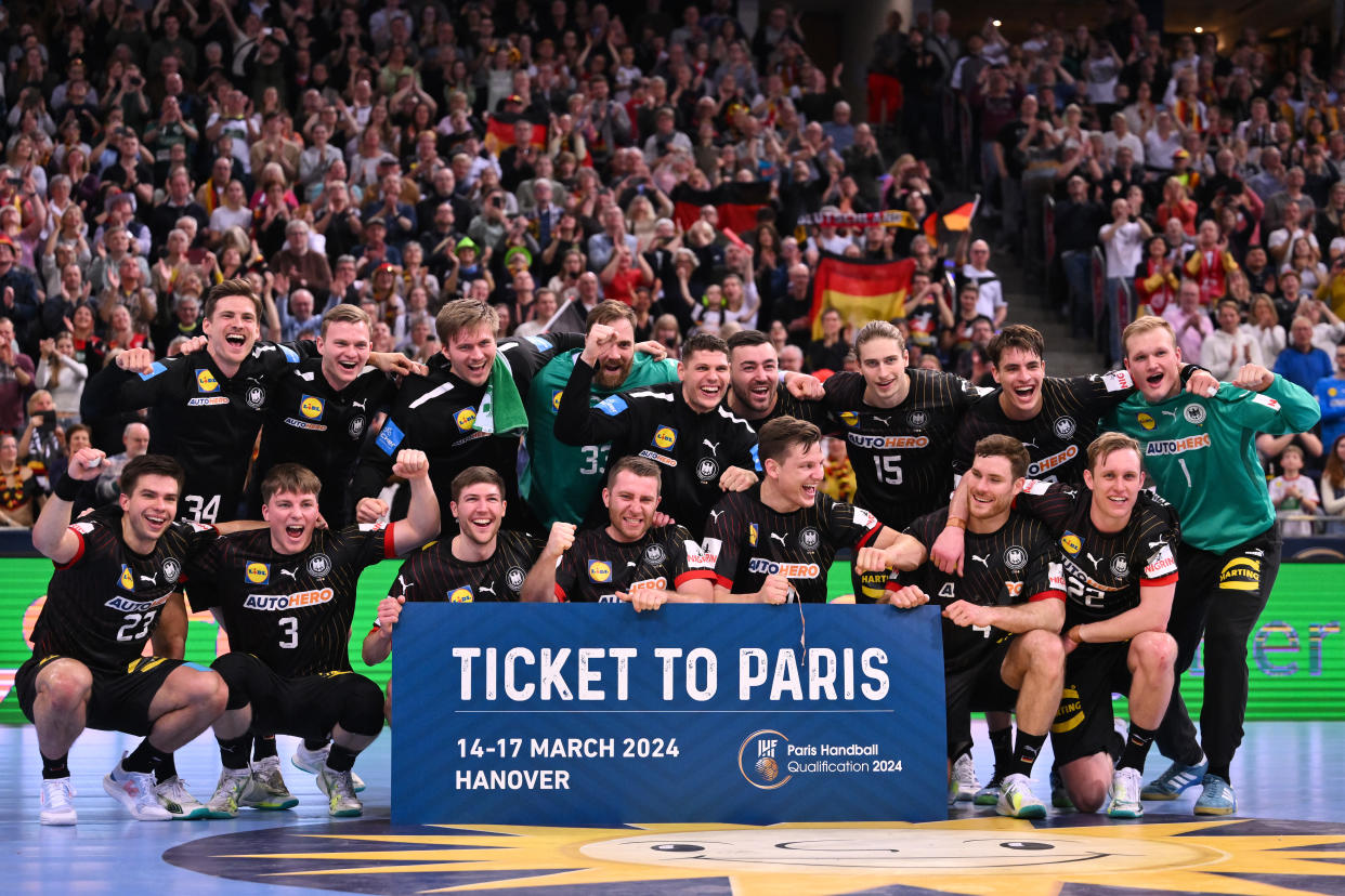 HANOVER, GERMANY - MARCH 17: Players of Germany celebrate with the Olympia Ticket after winning during the 2024 IHF Men's Olympic Qualification Tournament match between Austria and Germany at ZAG Arena on March 17, 2024 in Hanover, Germany.  (Photo by Oliver Hardt/Getty Images)