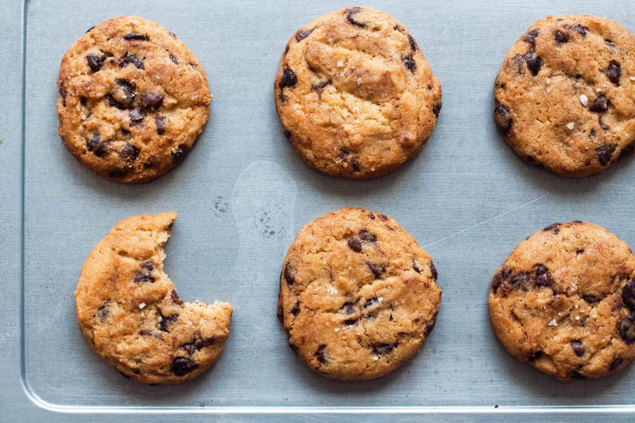 A batch of freshly baked cookies on a new baking sheet