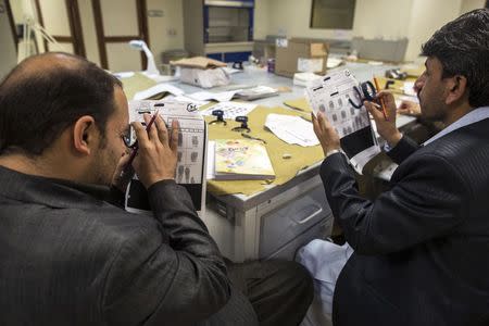 Forensic scientists practise classifying fingerprints at the fingerprint department at Punjab Forensic Science Agency in Lahore January 13, 2015. REUTERS/Zohra Bensemra