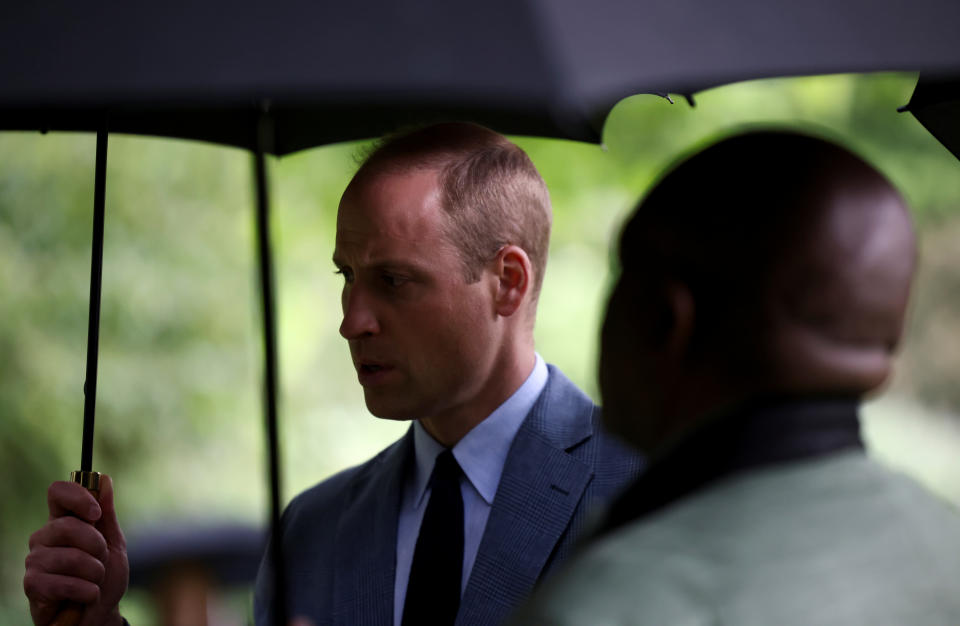 The Duke of Cambridge holds an umbrella as he attends a 'Big Tea' for NHS staff at Buckingham Palace in London, to mark the 73rd birthday of the NHS. Picture date: Monday July 5, 2021.