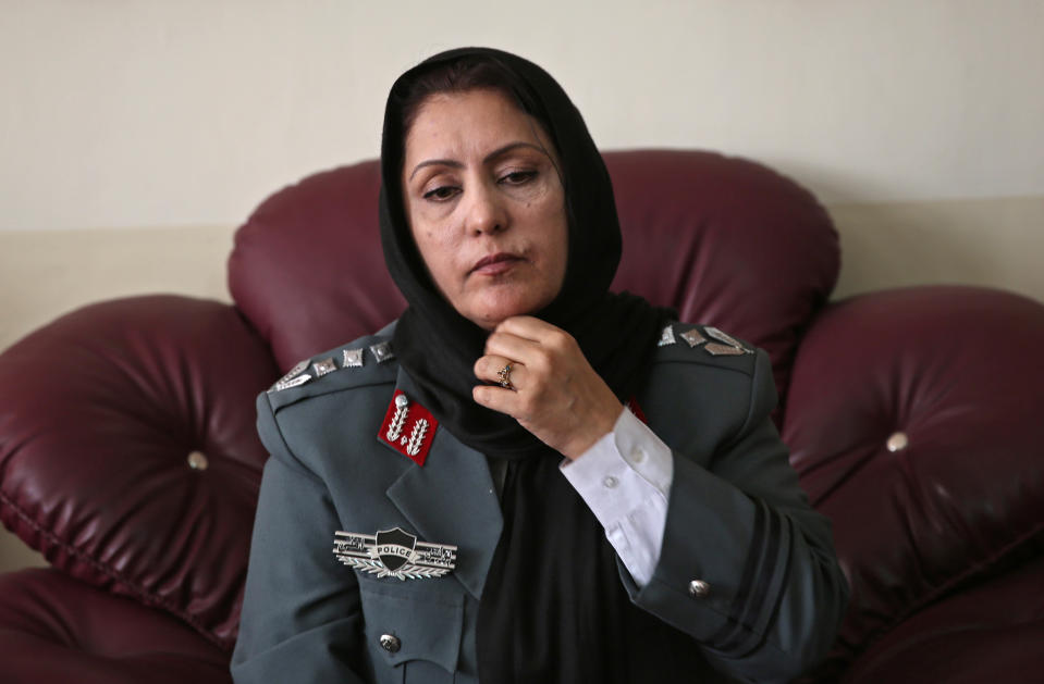Afghanistan's first-ever female district police chief, Col. Jamila Bayaz, 50, adjusts her scarf, preparing for an interview at her office in Kabul, Afghanistan, Thursday, Jan. 16, 2014. Afghanistan's first-ever female district police chief drew stares on Thursday as she drove and walked around the center of the city, reviewing check points and some of the important business and administrative facilities she is tasked with protecting. (AP Photo/Massoud Hossaini)